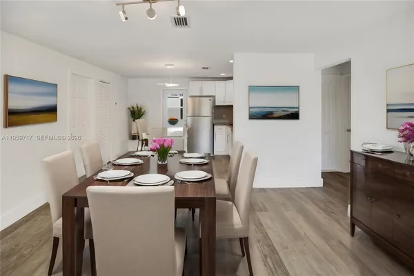 a view of a dining room with furniture and wooden floor