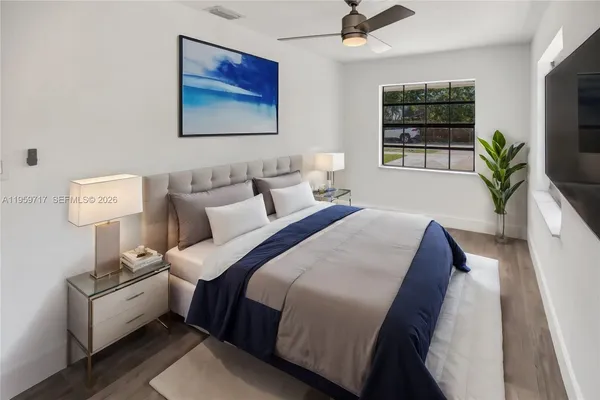 a bedroom with bed and a flat screen tv