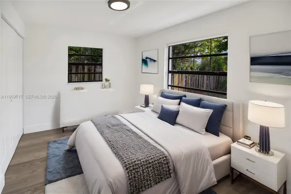 a bedroom with bed and a flat screen tv