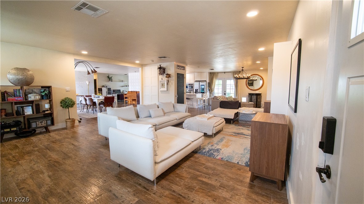 425 Blackridge Road Henderson, NV 89015 - Photo 3 of 31 Warm wood-look flooring and recessed lighting define this open-concept layout.