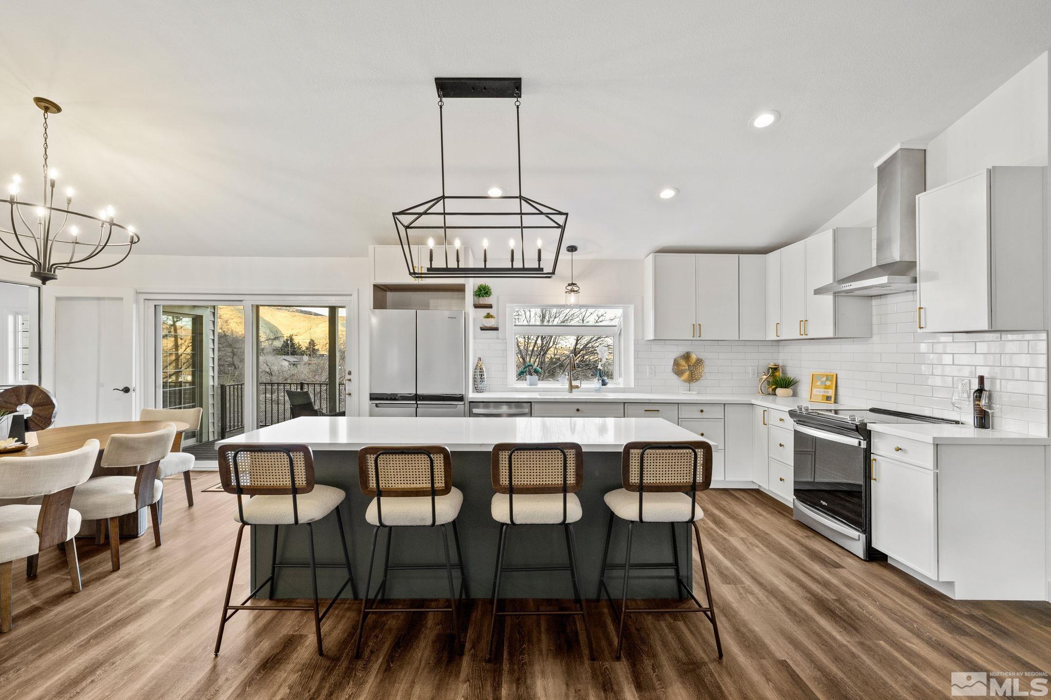 175 Del Mesa Circle Reno, NV 89521 - Photo 8 of 35 a kitchen with a dining table chairs wooden floor and appliances
