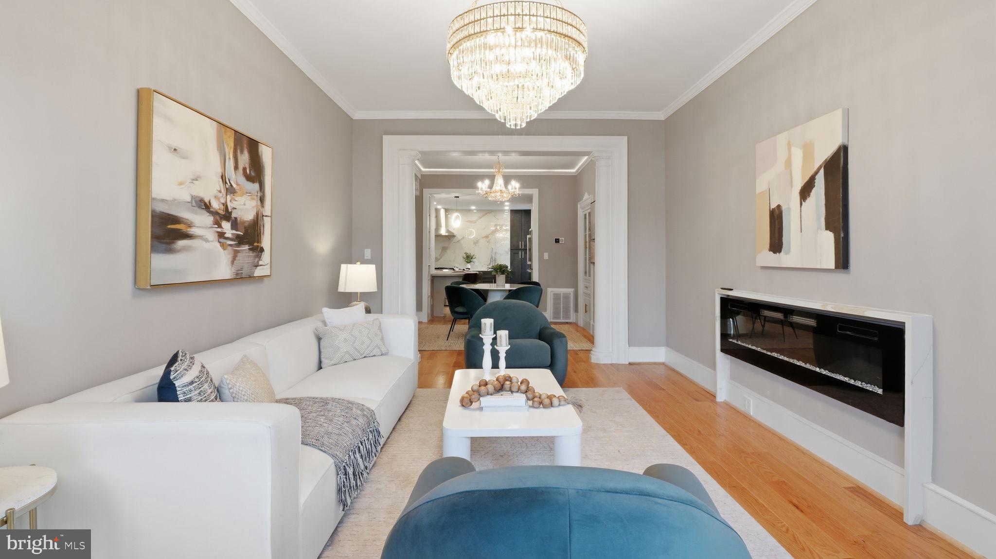 2205 California Street Northwest, Unit 303 Washington, DC 20008 - Photo 14 of 52 a living room with furniture a fireplace and a chandelier