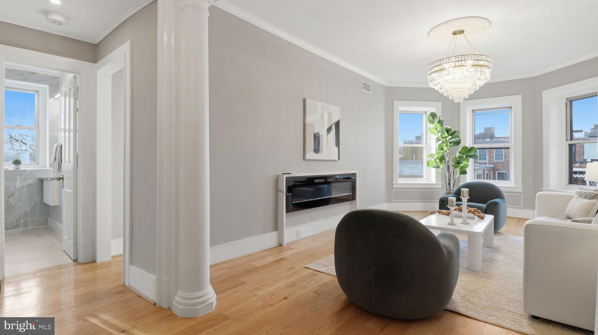 2205 California Street Northwest, Unit 303 Washington, DC 20008 - Photo 16 of 52 a living room with fireplace furniture and a chandelier