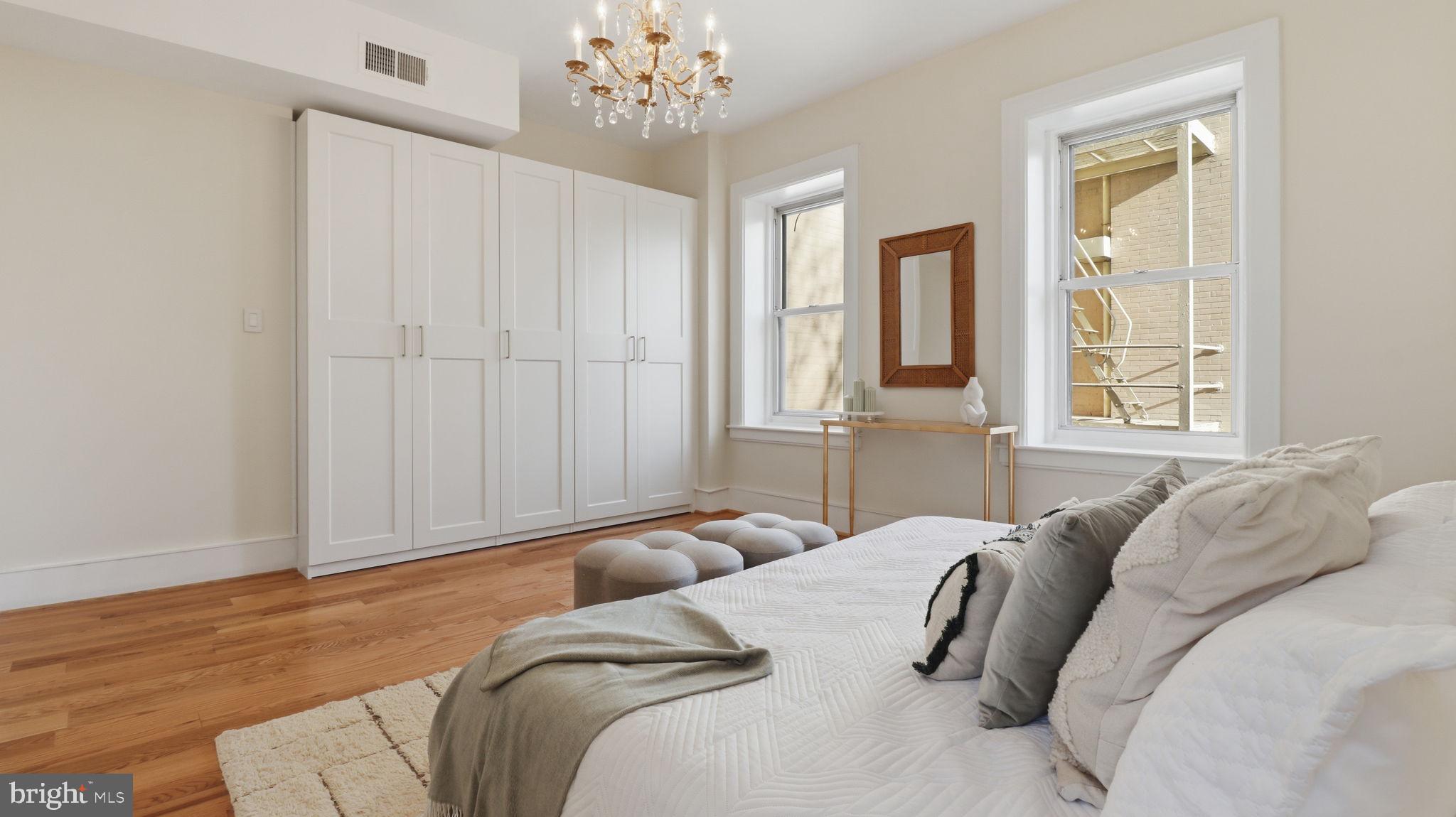 2205 California Street Northwest, Unit 303 Washington, DC 20008 - Photo 23 of 52 a bedroom with a large bed and a chandelier