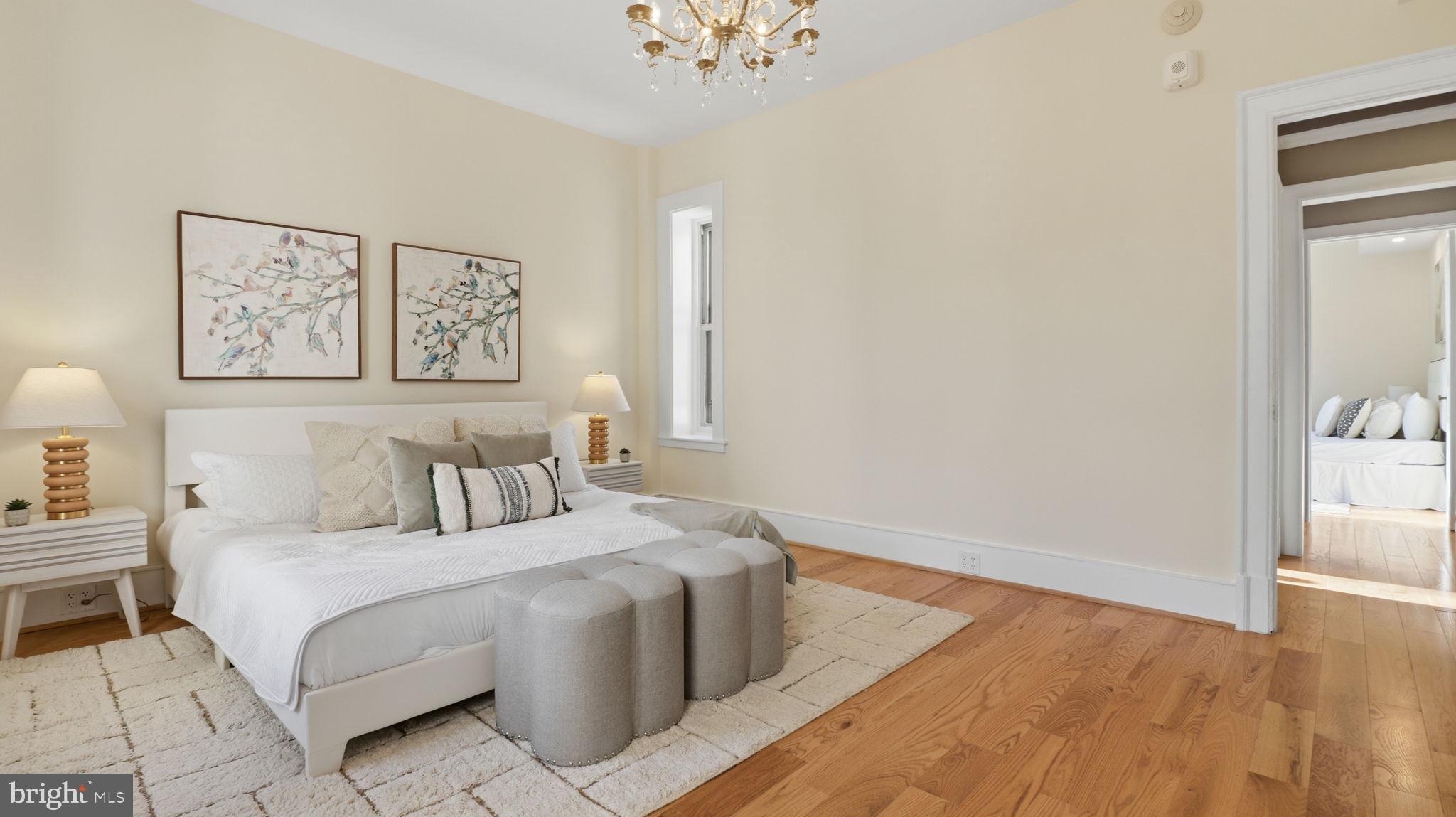 2205 California Street Northwest, Unit 303 Washington, DC 20008 - Photo 25 of 52 a bedroom with a bed and a chandelier