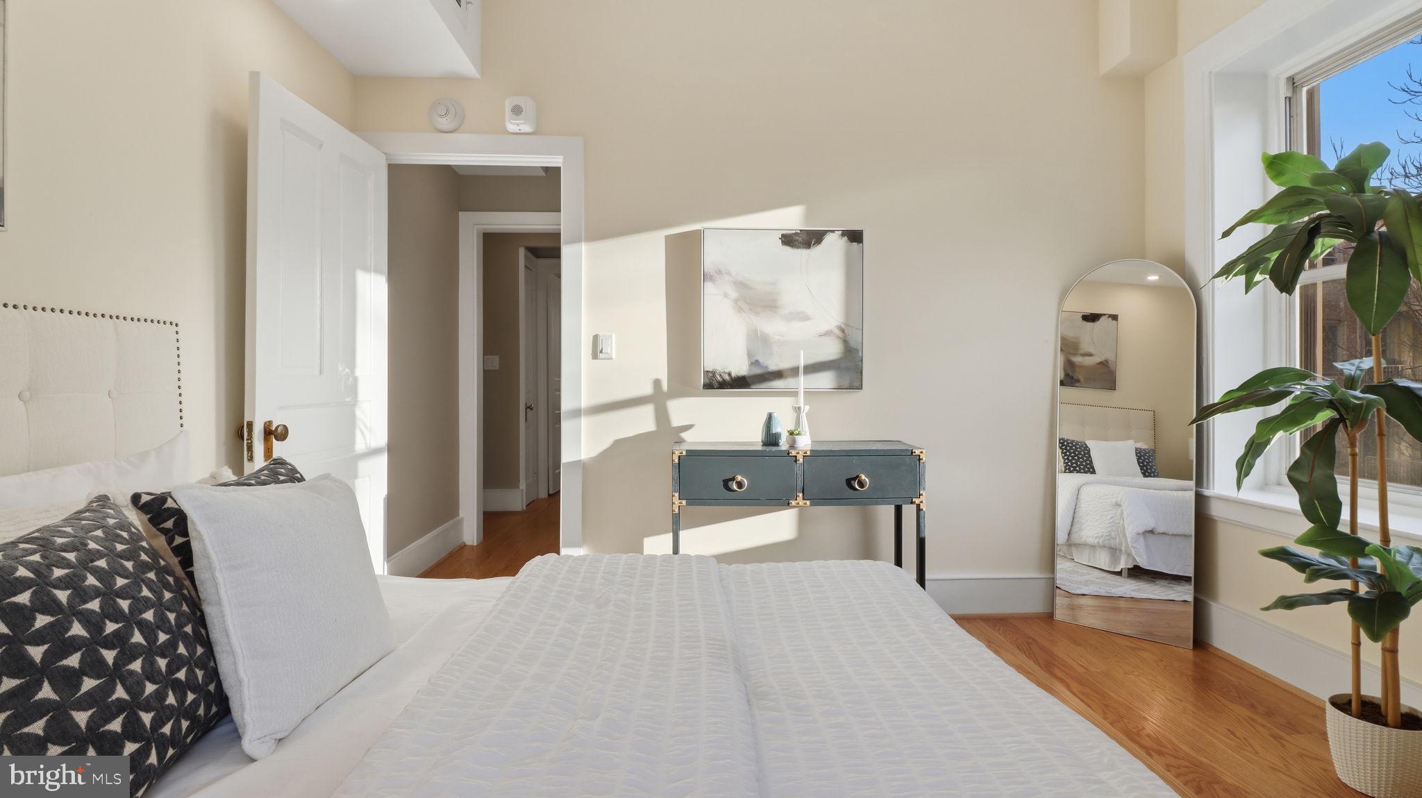 2205 California Street Northwest, Unit 303 Washington, DC 20008 - Photo 29 of 52 a bedroom with furniture and a potted plant