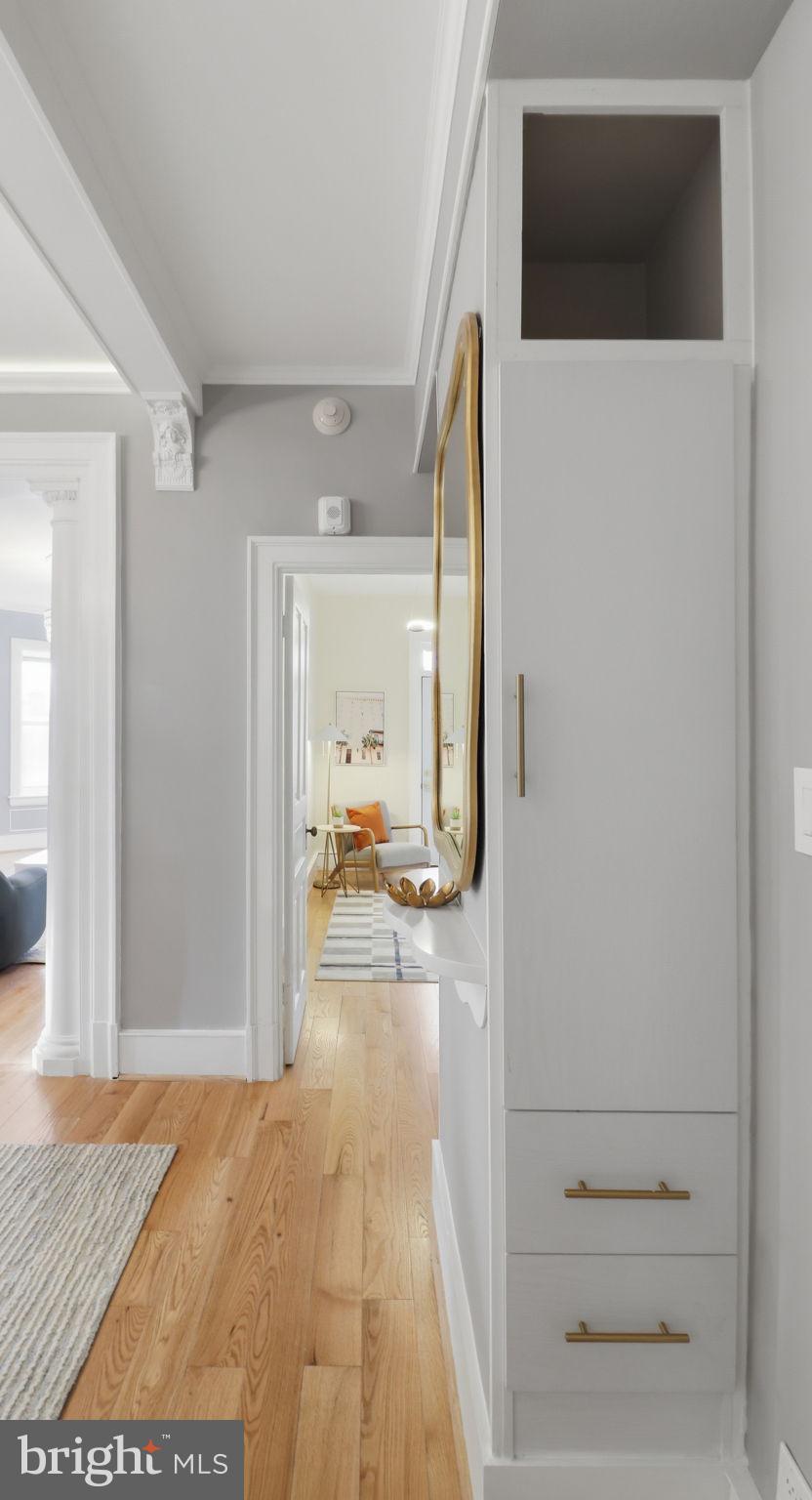 2205 California Street Northwest, Unit 303 Washington, DC 20008 - Photo 40 of 52 a view of a hallway with wooden floor and a living room