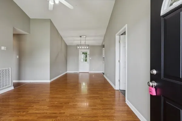 a view of an empty room with wooden floor