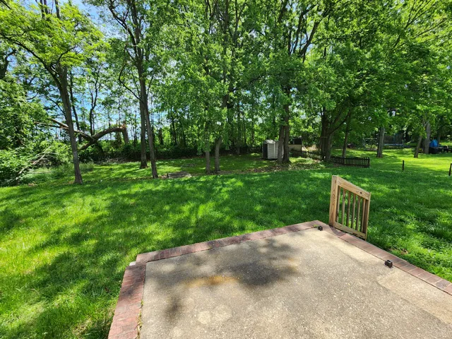 a view of green field with trees