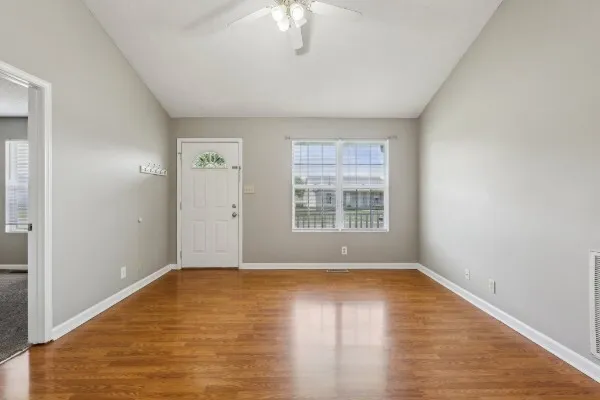 wooden floor in an empty room with a window