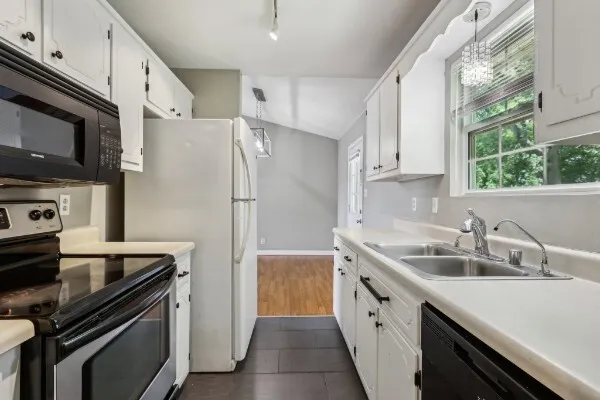 a kitchen with a sink stove and refrigerator