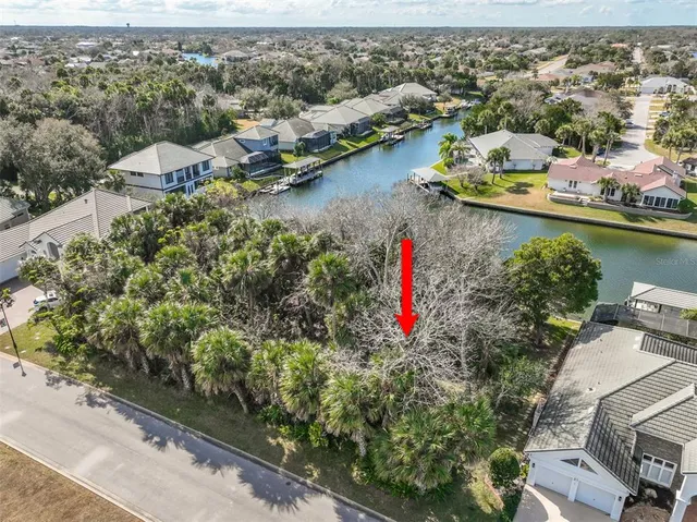 an aerial view of residential houses with outdoor space and lake view