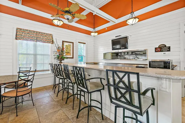 a outdoor space with lots of chairs and a table