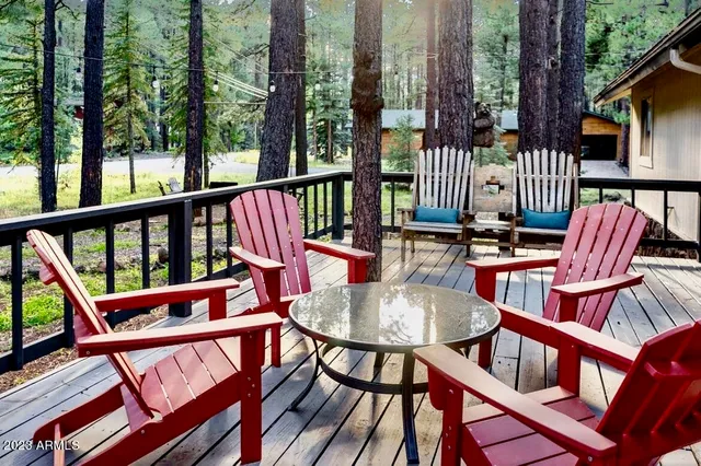 a kitchen with stainless steel appliances granite countertop a stove top oven a dining table and chairs with wooden floor