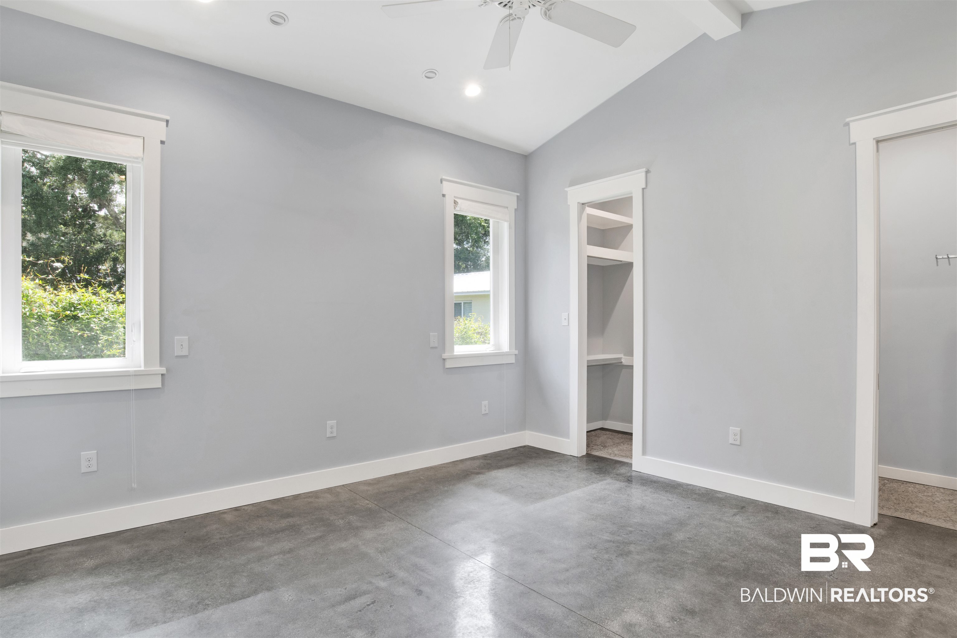 27980 Canal Road Orange Beach, AL 36561 - Photo 30 of 46 Unfurnished bedroom featuring concrete flooring, a walk in closet, recessed lighting, and a ceiling fan