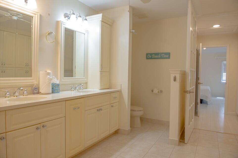 114 Beach Summit Court Jupiter, FL 33477 - Photo 23 of 32 a bathroom with a double vanity sink and mirror