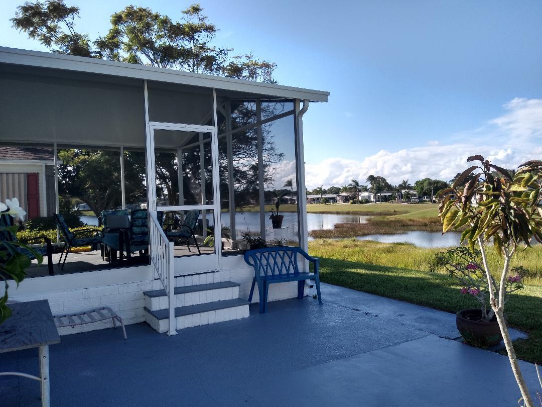 504 Thames Bluff Ridge Fort Pierce, FL 34982 - Photo 34 of 35 Back Screened in area and lake