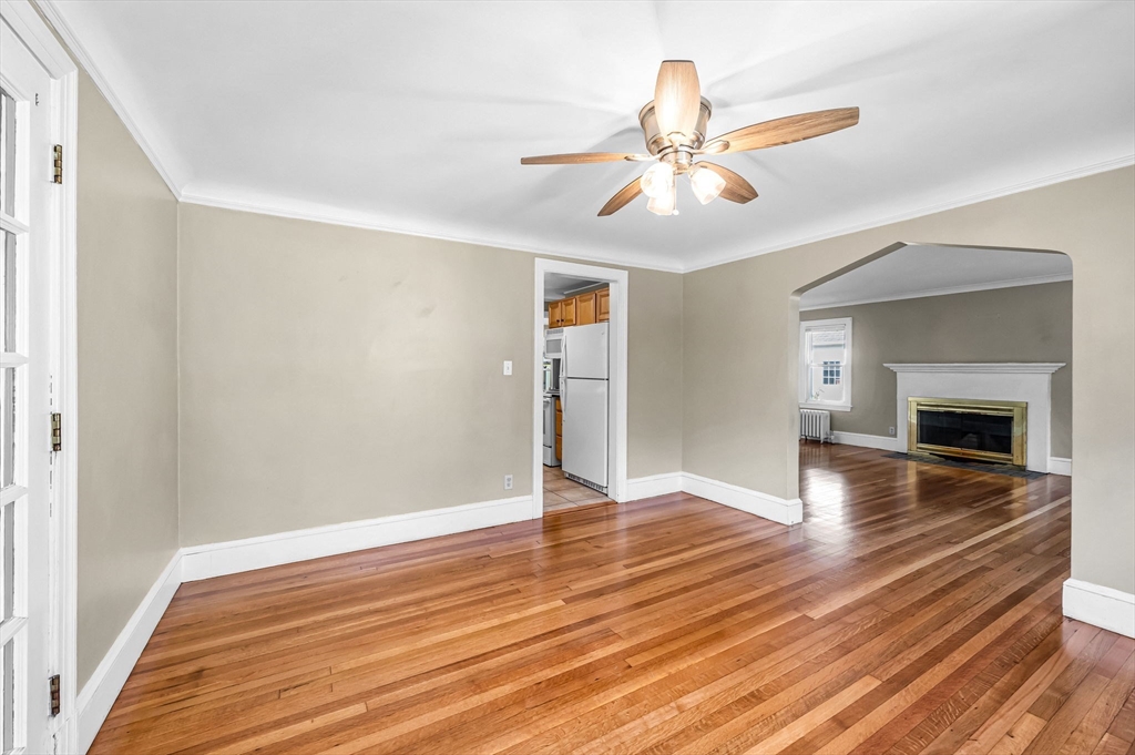 33 Emerson Road Longmeadow, MA 01106 - Photo 11 of 42 an empty room with wooden floor chandelier fan and windows