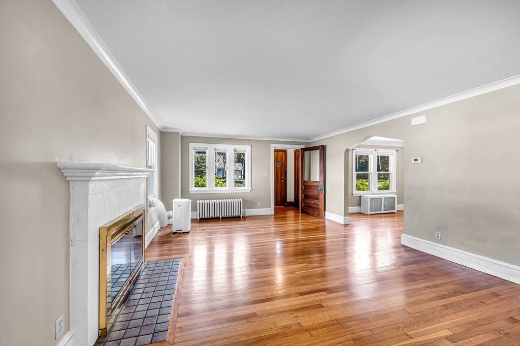 33 Emerson Road Longmeadow, MA 01106 - Photo 3 of 42 a view of a livingroom with wooden floor and a fireplace