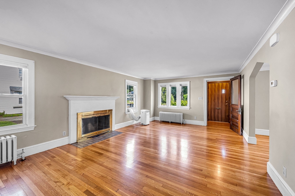 33 Emerson Road Longmeadow, MA 01106 - Photo 6 of 42 a view of a livingroom with wooden floor and a fireplace
