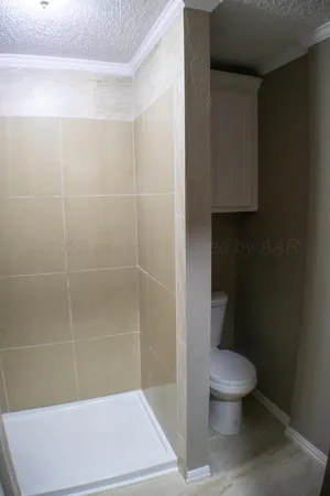 a bathroom with a toilet and a shower