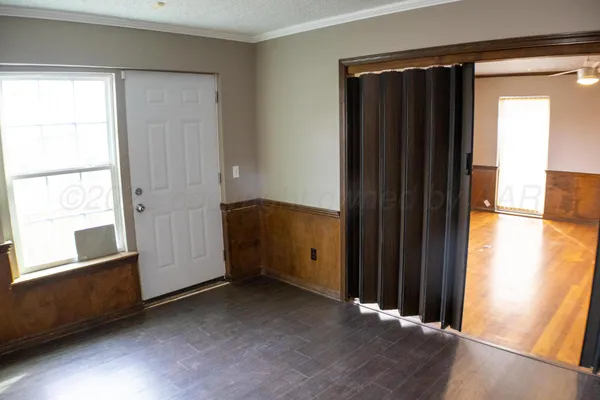 an empty room with windows and closet