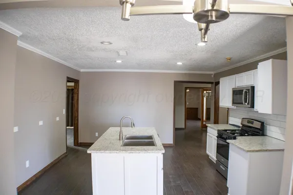 a kitchen with a stove and a sink