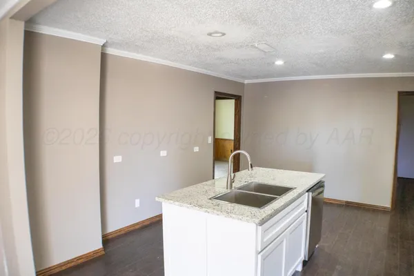 a kitchen with a stove a sink and a refrigerator