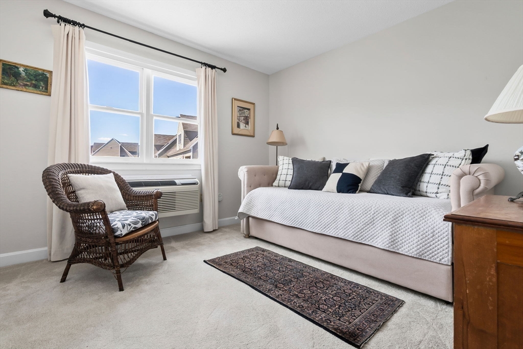 117 Water Street, Unit 28 Beverly, MA 01915 - Photo 17 of 35 a bedroom with a bed a couch and large window