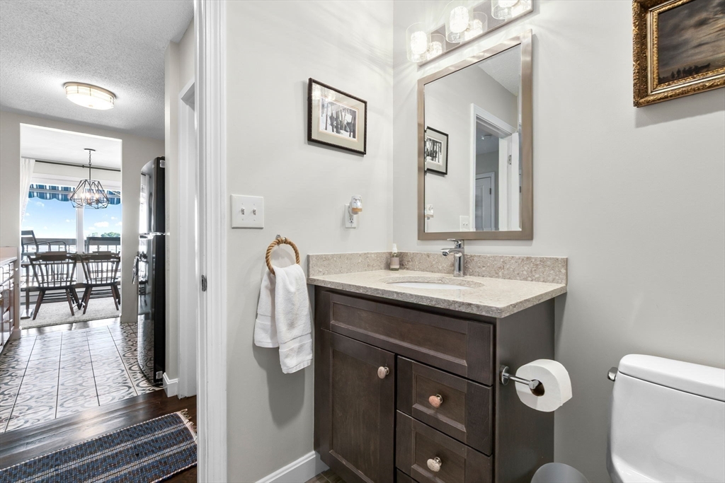 117 Water Street, Unit 28 Beverly, MA 01915 - Photo 19 of 35 a bathroom with a granite countertop sink toilet and shower