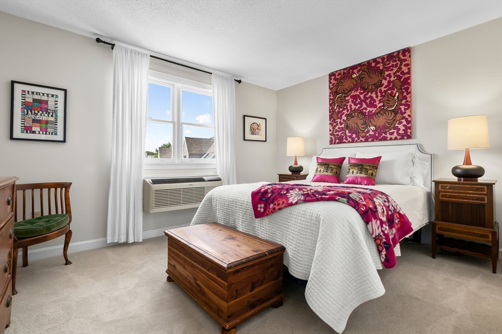 117 Water Street, Unit 28 Beverly, MA 01915 - Photo 21 of 35 a spacious bedroom with a bed and a cabinets