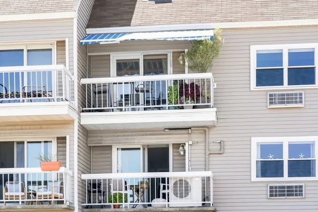 a living room with furniture and large windows