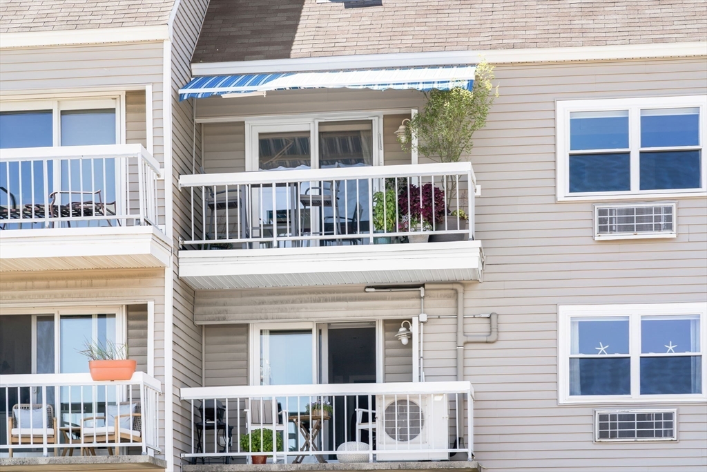 117 Water Street, Unit 28 Beverly, MA 01915 - Photo 32 of 35 a front view of a house with large windows