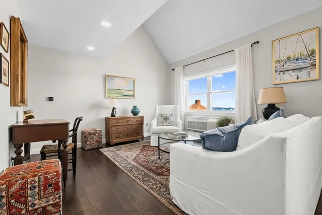 a living room with furniture a rug and a piano