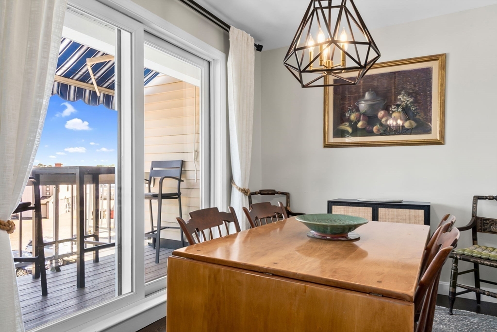 117 Water Street, Unit 28 Beverly, MA 01915 - Photo 10 of 35 a bedroom with a bed and a chandelier