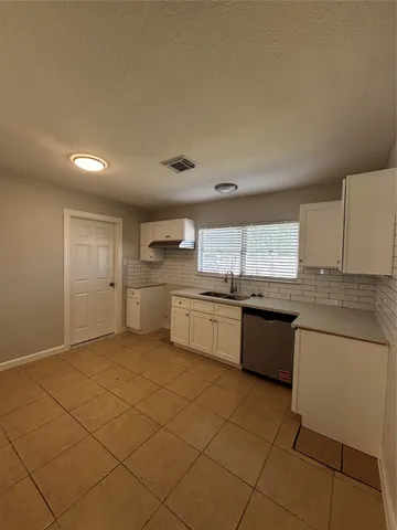 a kitchen with stainless steel appliances granite countertop a sink and cabinets