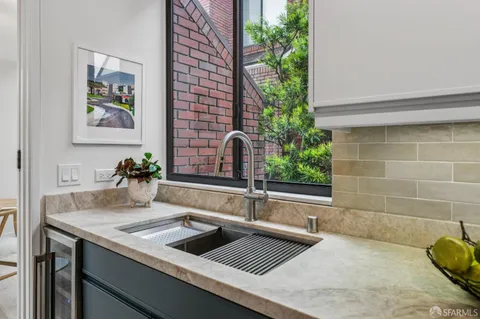 a kitchen with a sink and a potted plant