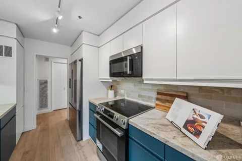 a kitchen that has a sink and a stove top oven