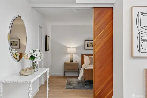 a living room with furniture and a mirror