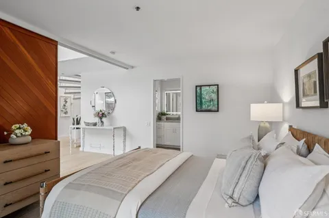 a bedroom with a bed and a couch