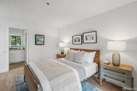 a bedroom with a bed and a lamp