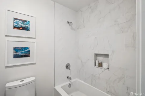 a bathroom with a toilet and a bathtub
