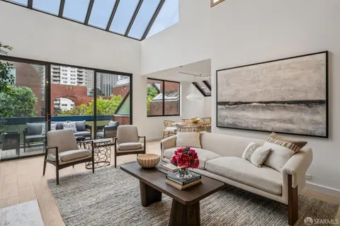 a living room with furniture and a floor to ceiling window