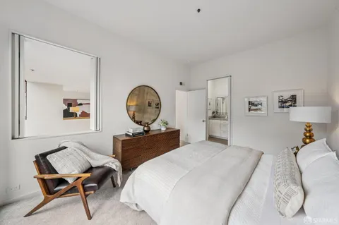 a bedroom with a bed and a lamp on table