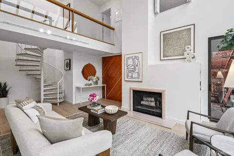 a living room with furniture fireplace and a window