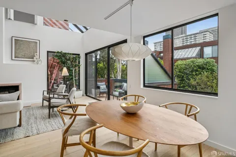 a view of a dining room with furniture wooden floor and chandelier