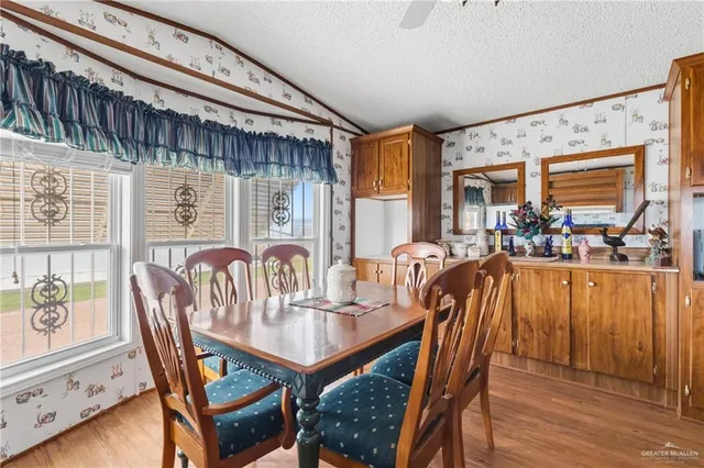 a dining room with furniture window and wooden floor