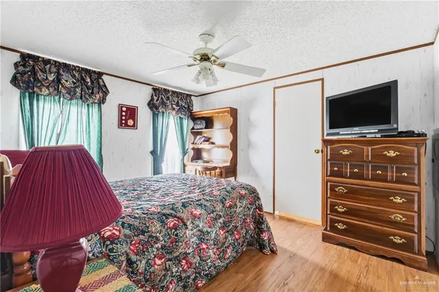 a bedroom with a bed and a flat screen television