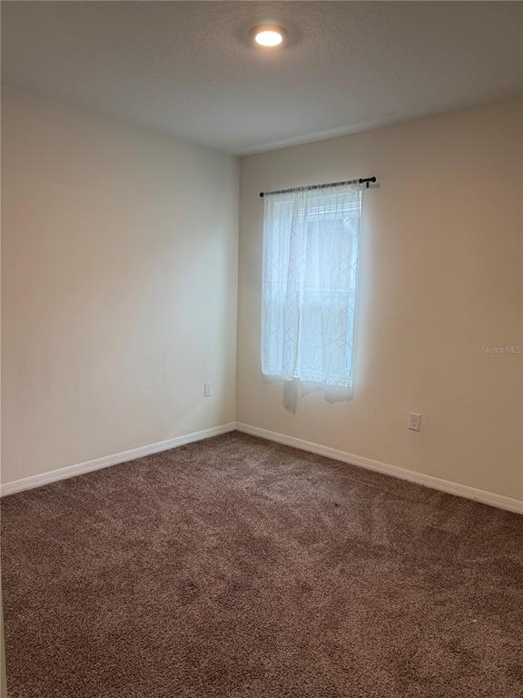 569 Talisi Loop St. Cloud, FL 34771 - Photo 11 of 20 an empty room with windows