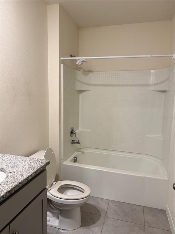 569 Talisi Loop St. Cloud, FL 34771 - Photo 10 of 20 a bathroom with a granite countertop bathtub toilet and sink